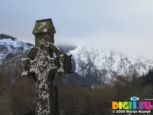 SX02633 Celtic cross in Glendalough with view to Lugduff mountain